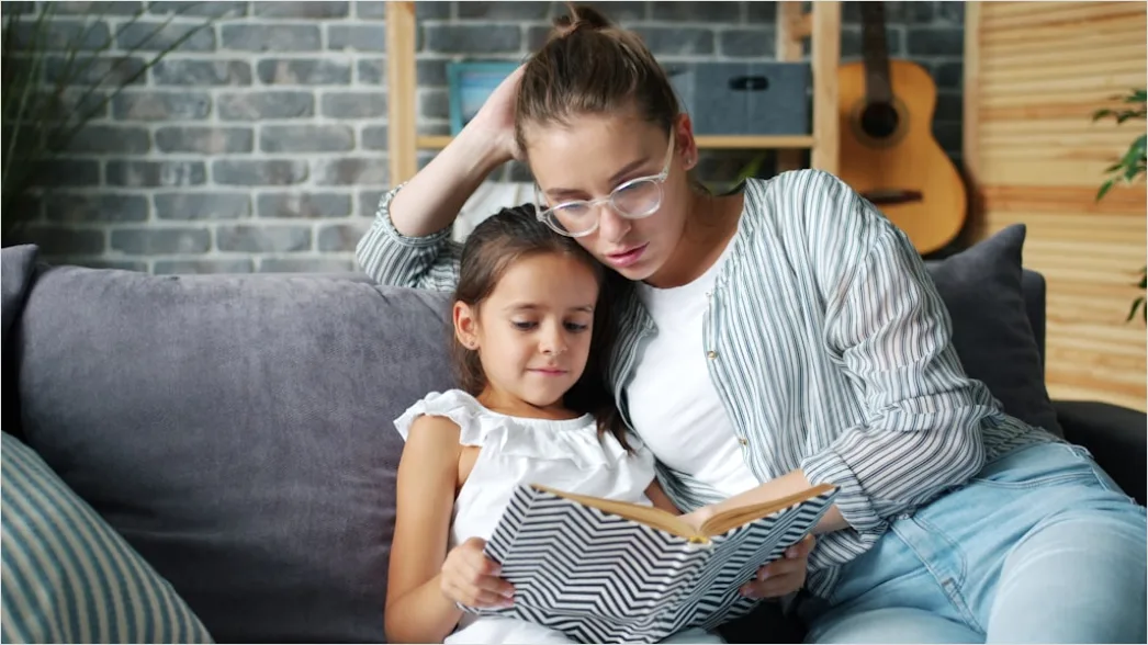 Detail Child Reading Book With Parent At Home Number 3