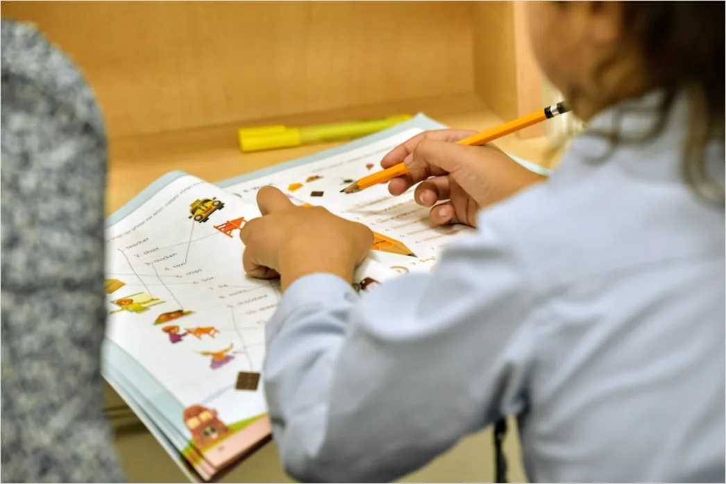 Detail High School Teacher Helping Student At Desk Number 14