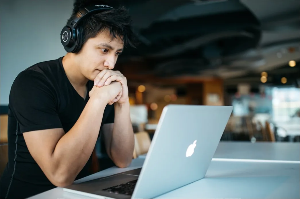 Student Wearing Headphones Watching Online Lecture 6104