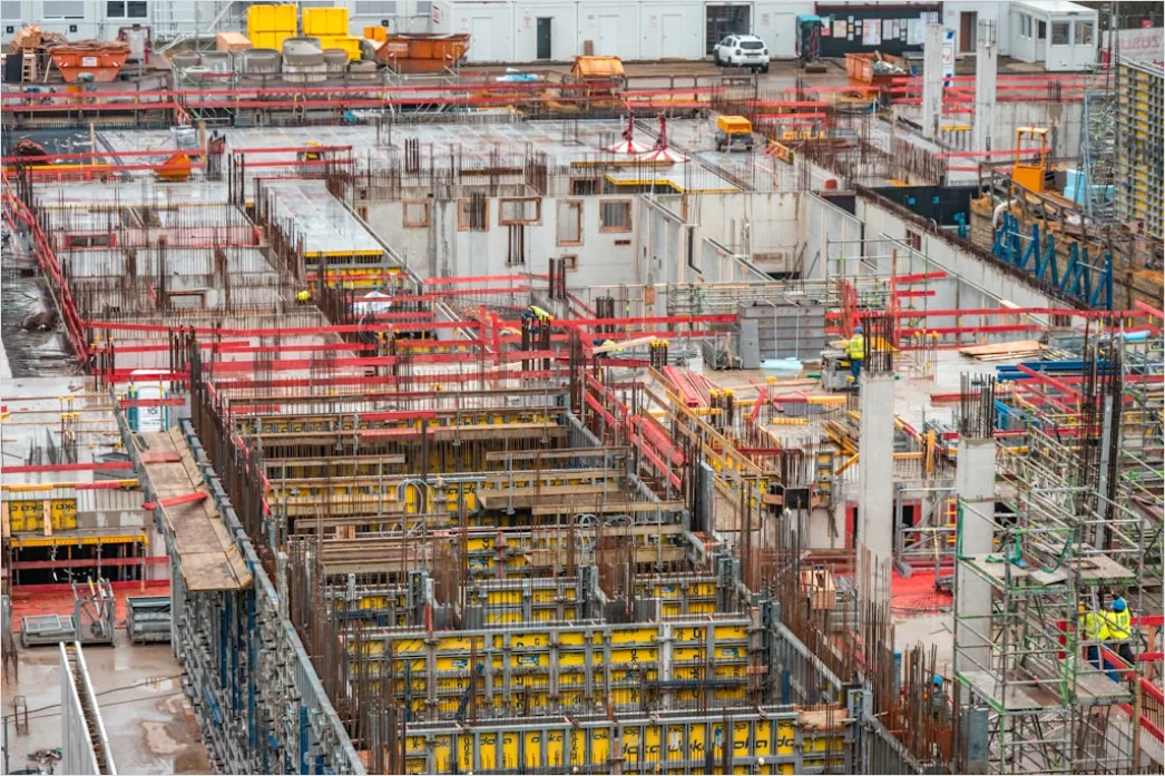 Construction Worker Pouring Concrete Foundation Site