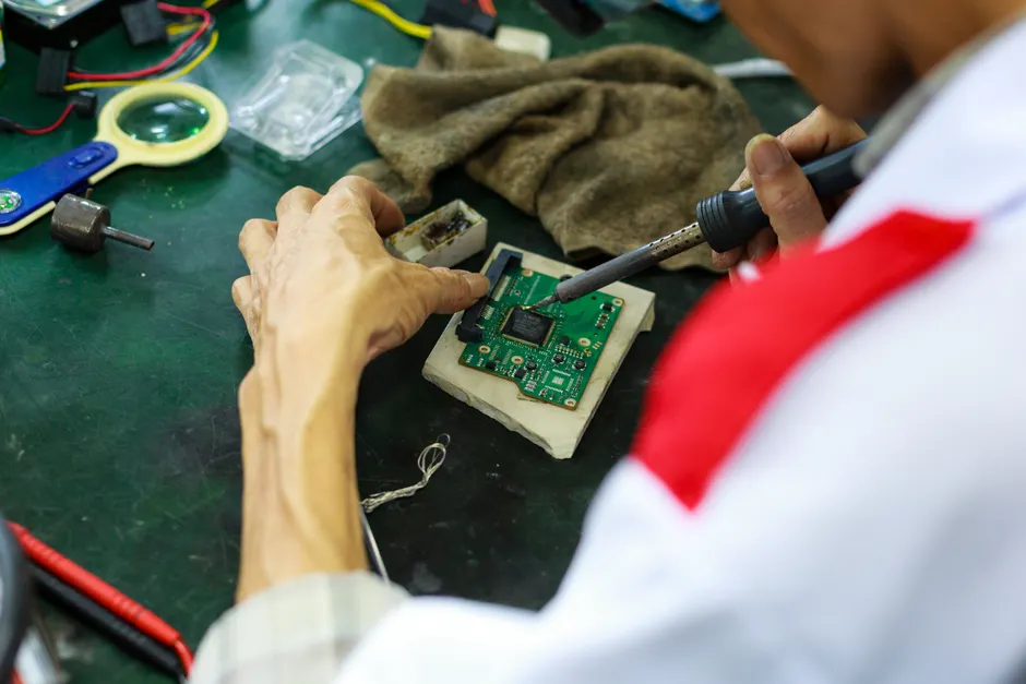 Detail Electronics Assembly Line Workers Soldering Circuit Boards Number 12