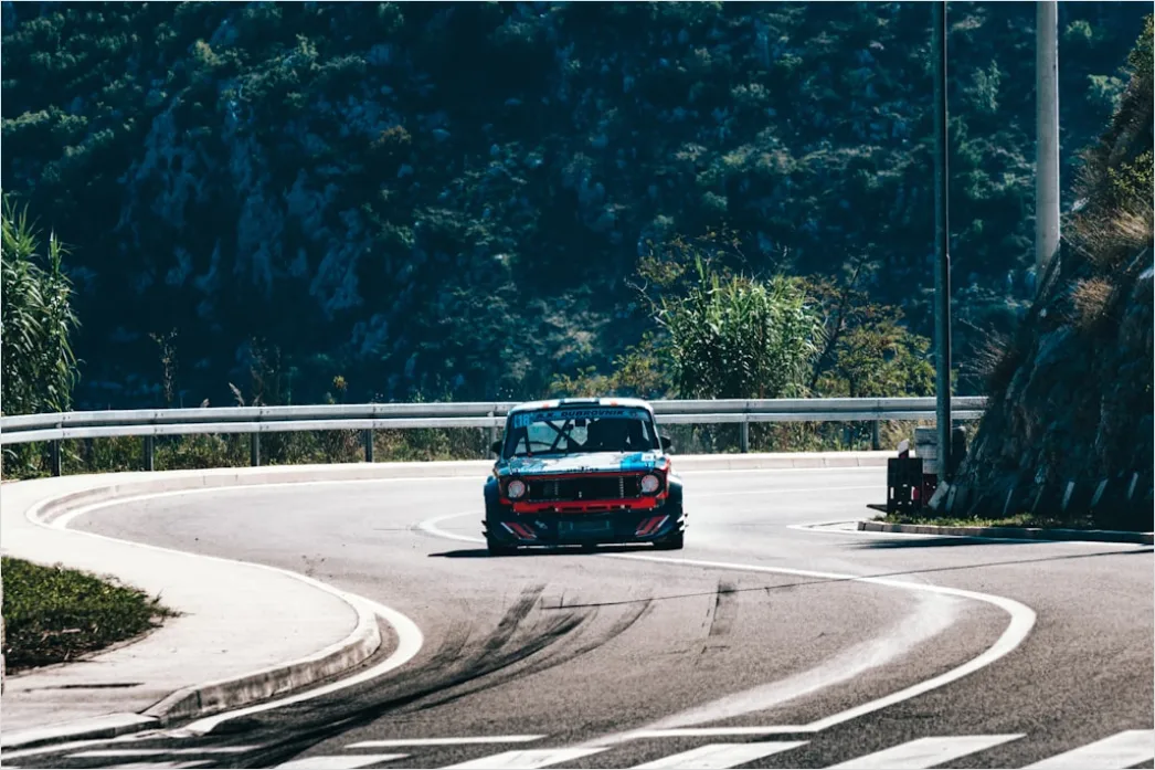 Detail Ferrari Driving On Coastal Road Aerial View Number 3