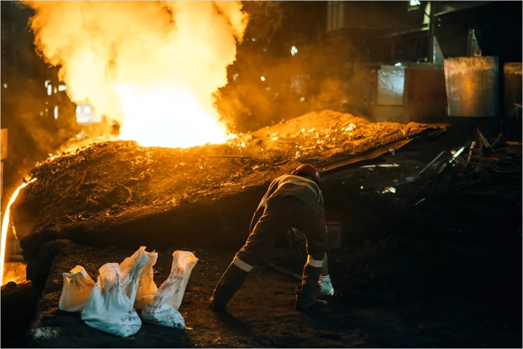 Iron Foundry Worker Pouring Molten Iron Mold