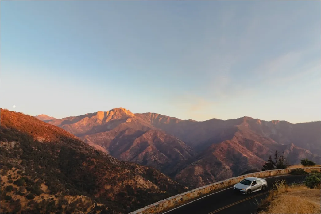 Detail Luxury Sports Car On Mountain Road Sunset Number 2