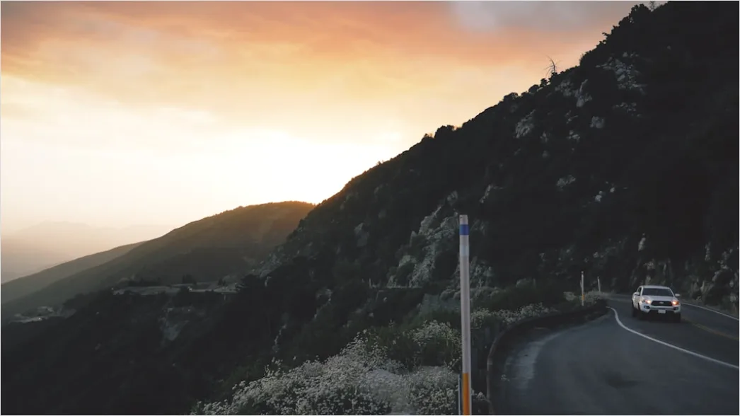 Detail Luxury Sports Car On Mountain Road Sunset Number 3