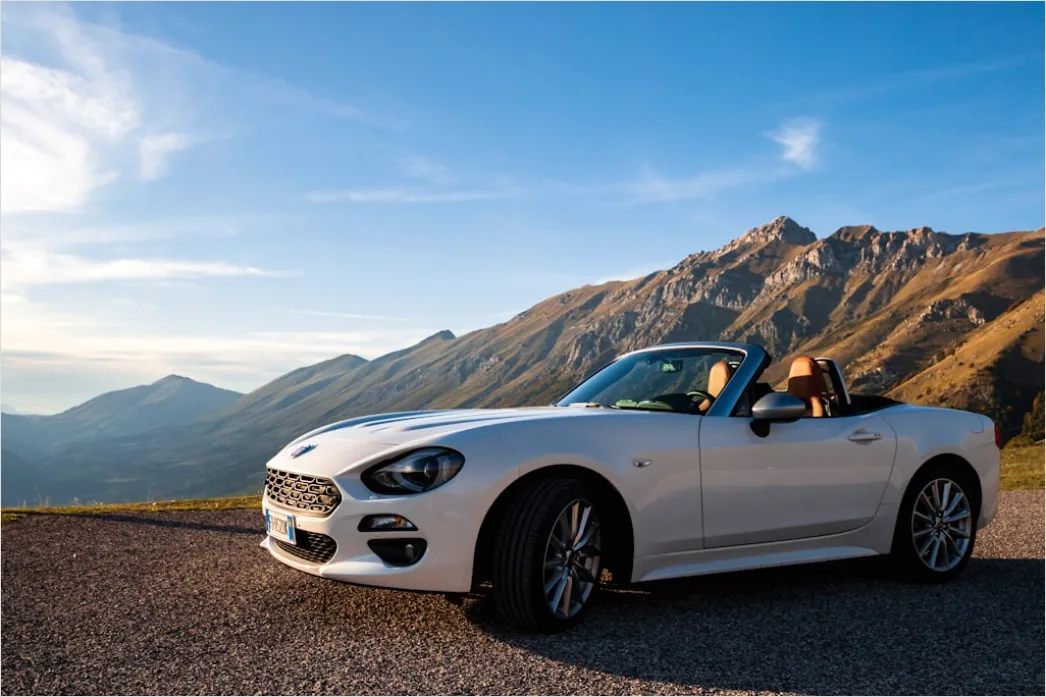 Detail Luxury Sports Car On Mountain Road Sunset Number 6