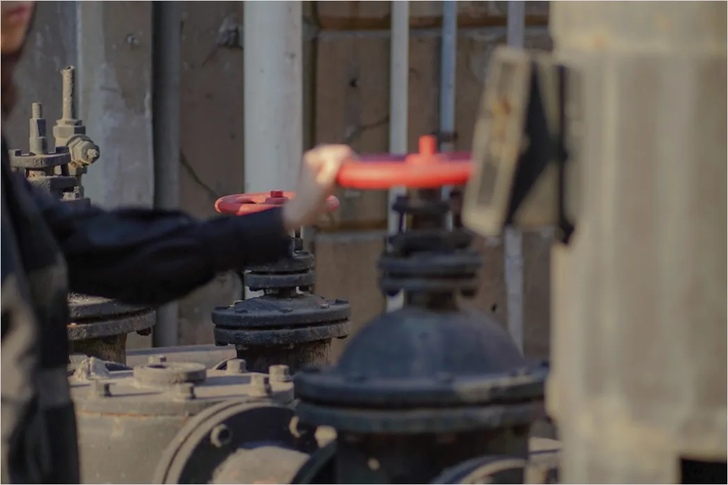 Refinery Worker In Safety Gear Checking Gauges