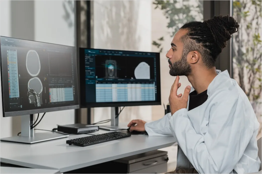 Researcher Analyzing Data On Multiple Monitors Df96