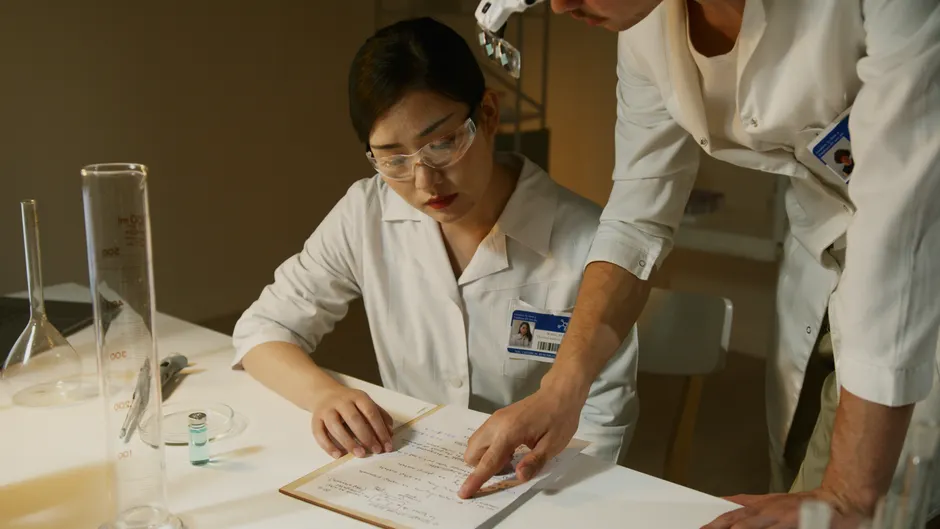 Detail Scientist Writing Notes In Lab Notebook Number 14