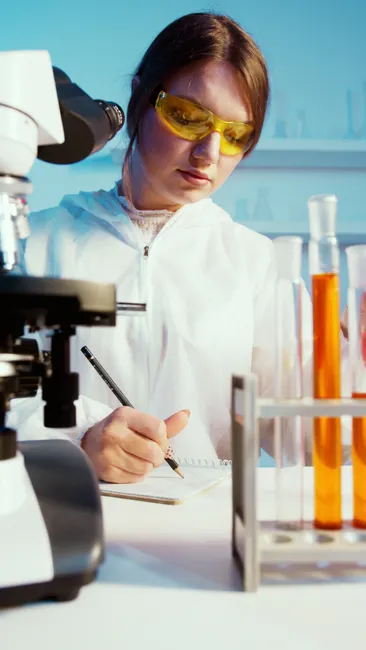 Detail Scientist Writing Notes In Lab Notebook Number 15