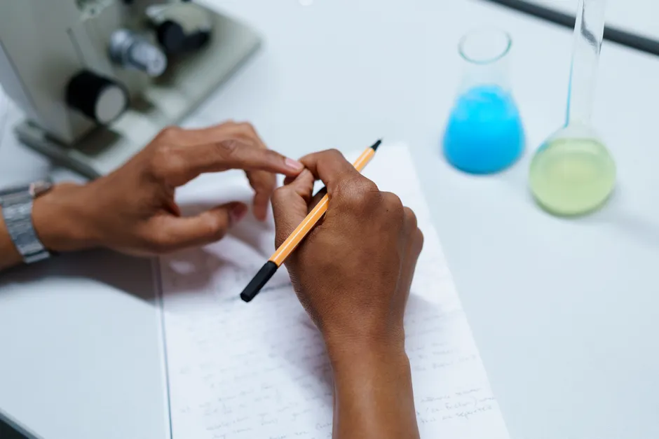 Detail Scientist Writing Notes In Lab Notebook Number 4