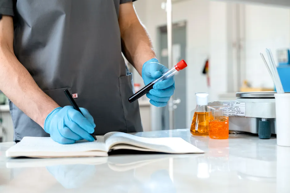 Detail Scientist Writing Notes In Lab Notebook Number 7