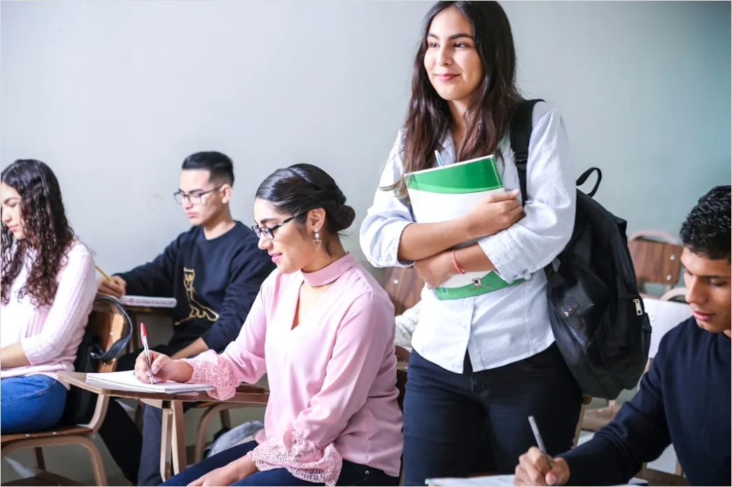 Detail Teacher And Aide Supporting Student In Class Number 2