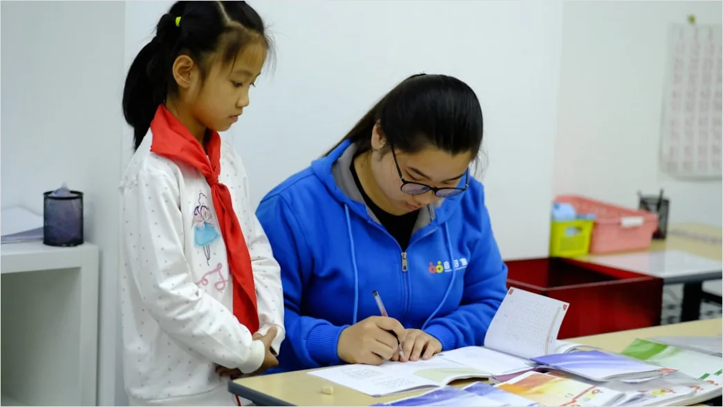 Detail Teacher And Aide Supporting Student In Class Number 19