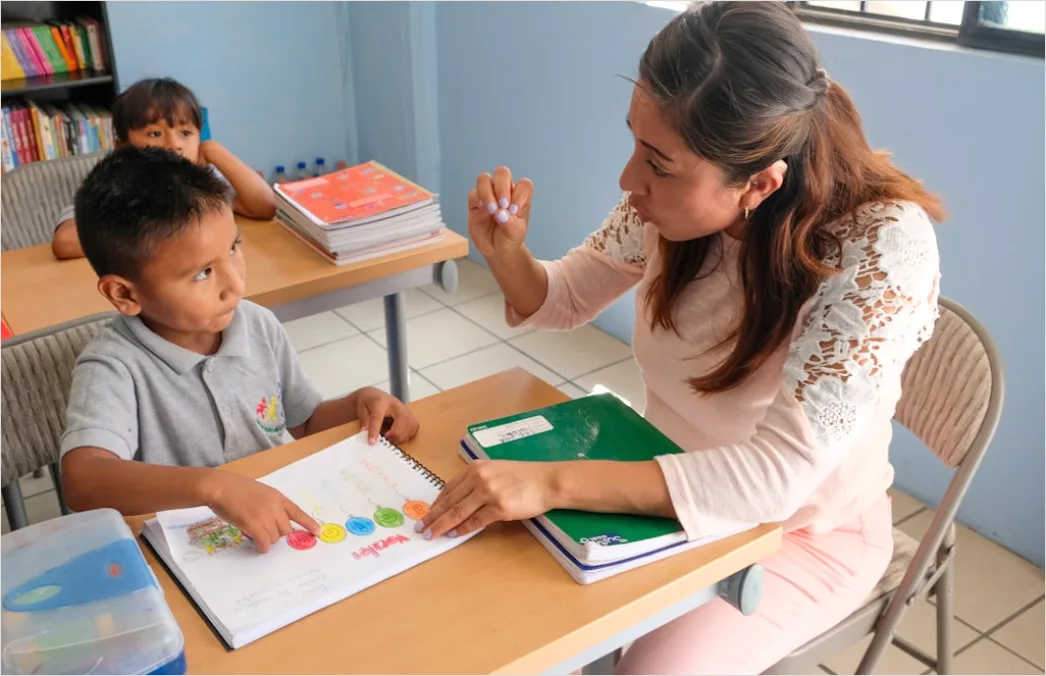 Detail Teacher And Aide Supporting Student In Class Number 5
