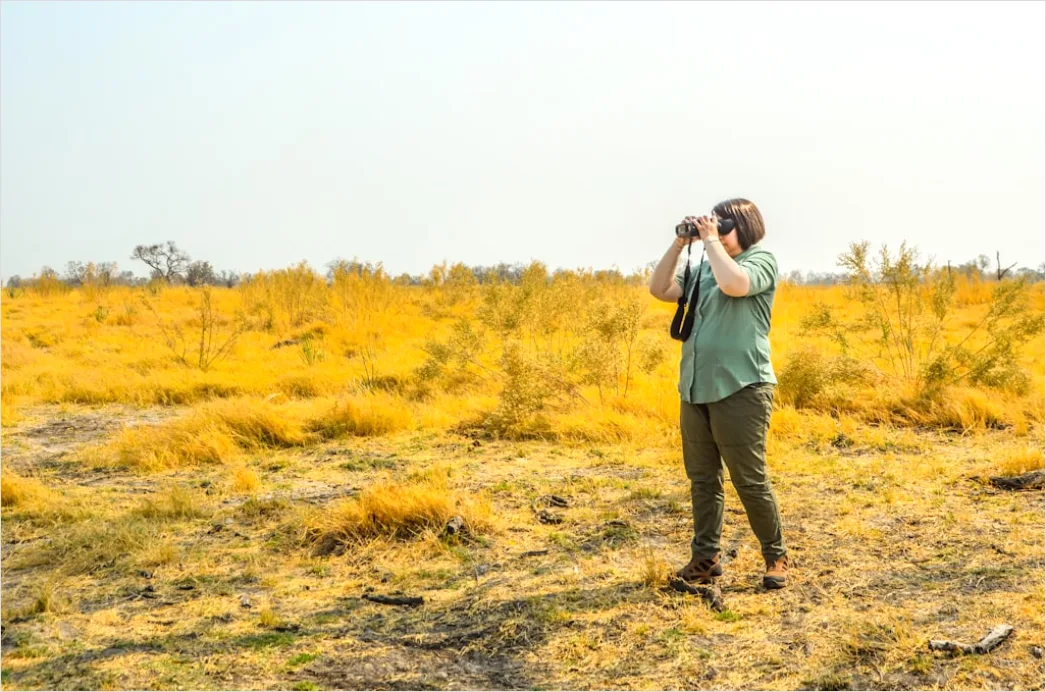 Detail Wildlife Researcher Observing Animals With Binoculars Number 12