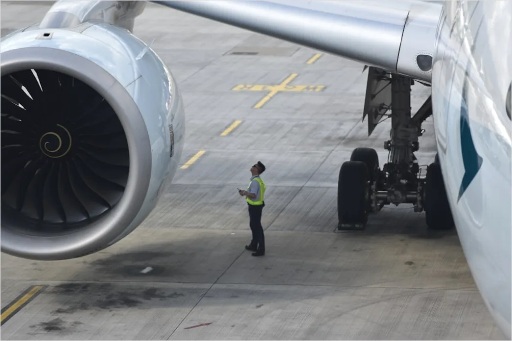 Detail Aircraft Maintenance Engineer Inspecting Engine Number 4