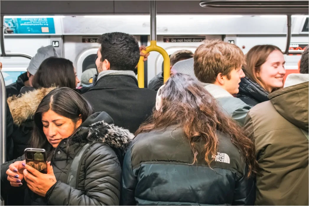 Detail Commuters On Subway Train Reading Phones Number 2