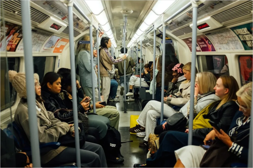 Detail Commuters On Subway Train Reading Phones Number 6