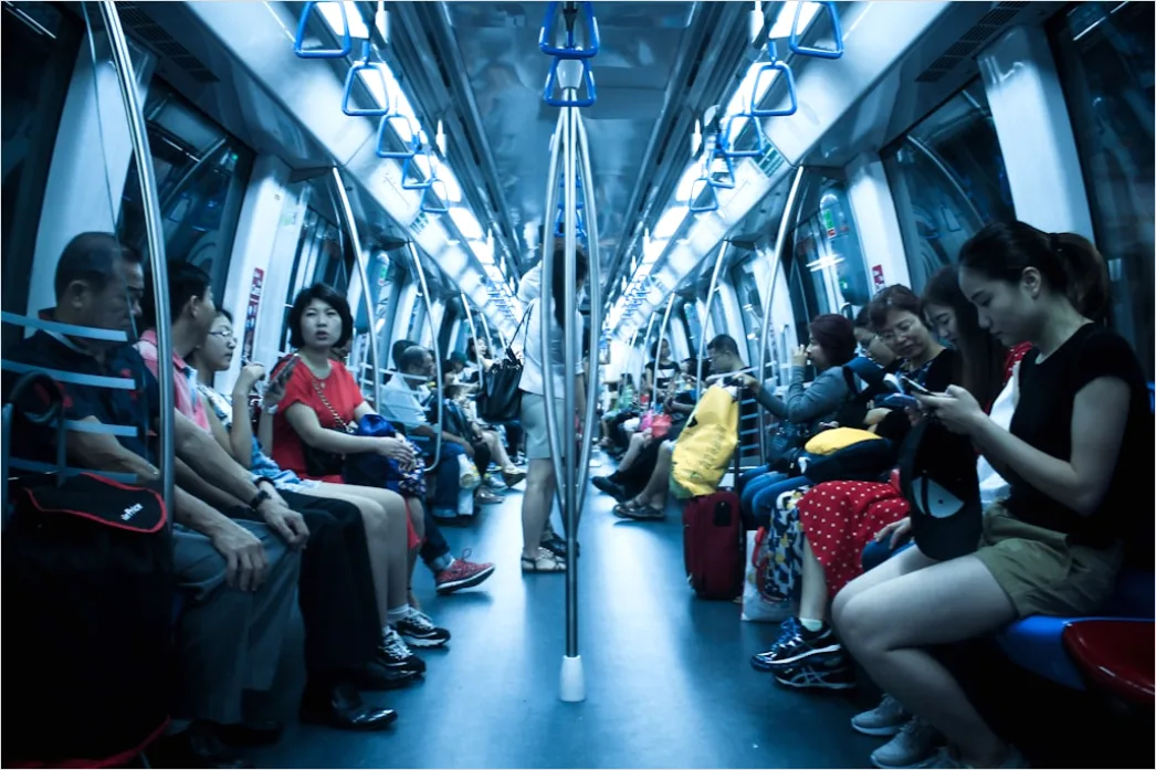 Detail Commuters On Subway Train Reading Phones Number 7