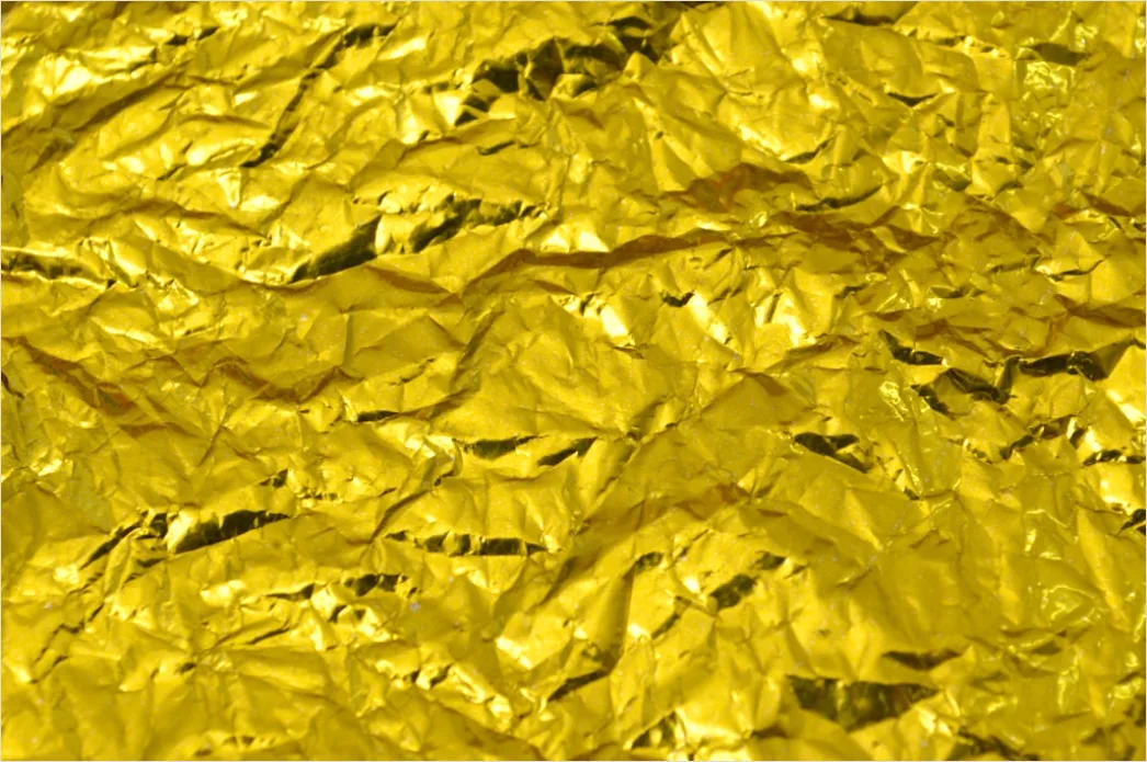 Goldene Metalloberflaeche Mit Lichtreflexen