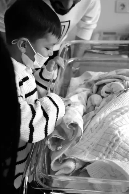 Detail New Big Sibling Holding Newborn Gently Number 14