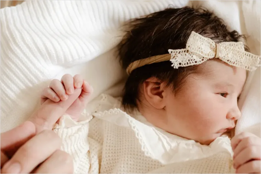 Detail New Big Sibling Holding Newborn Gently Number 7