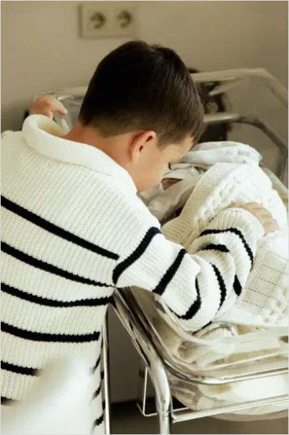 Detail New Big Sibling Holding Newborn Gently Number 10
