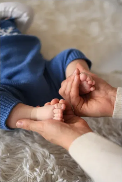 Detail Mother Hands Holding Baby Feet Number 2