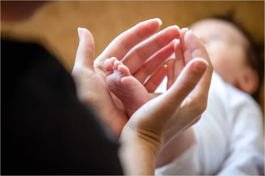 Detail Mother Hands Holding Baby Feet Number 3