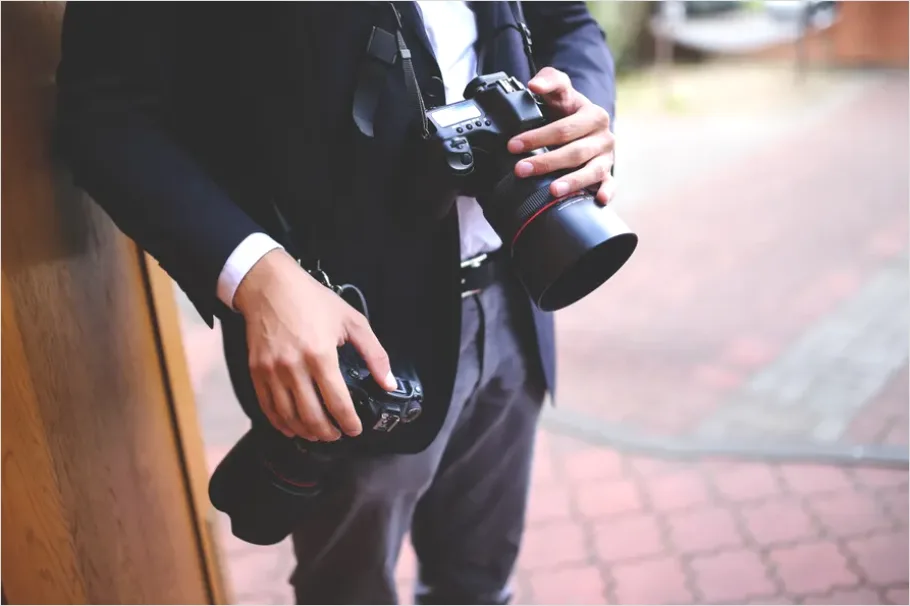 Detail Photographer Holding Camera Portrait Number 3