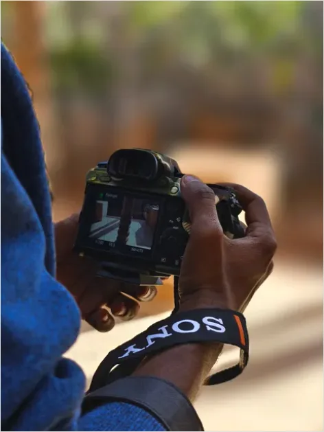 Detail Photographer Holding Camera Portrait Number 4