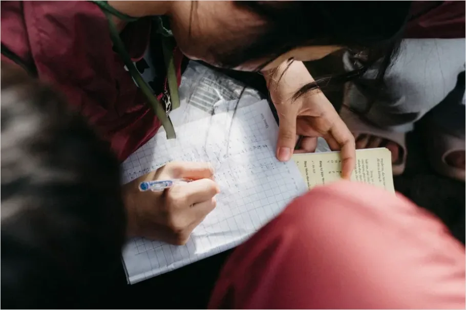 Detail Student Writing Notes In Notebook Number 3