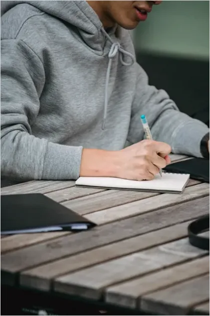 Detail Student Writing Notes In Notebook Number 4