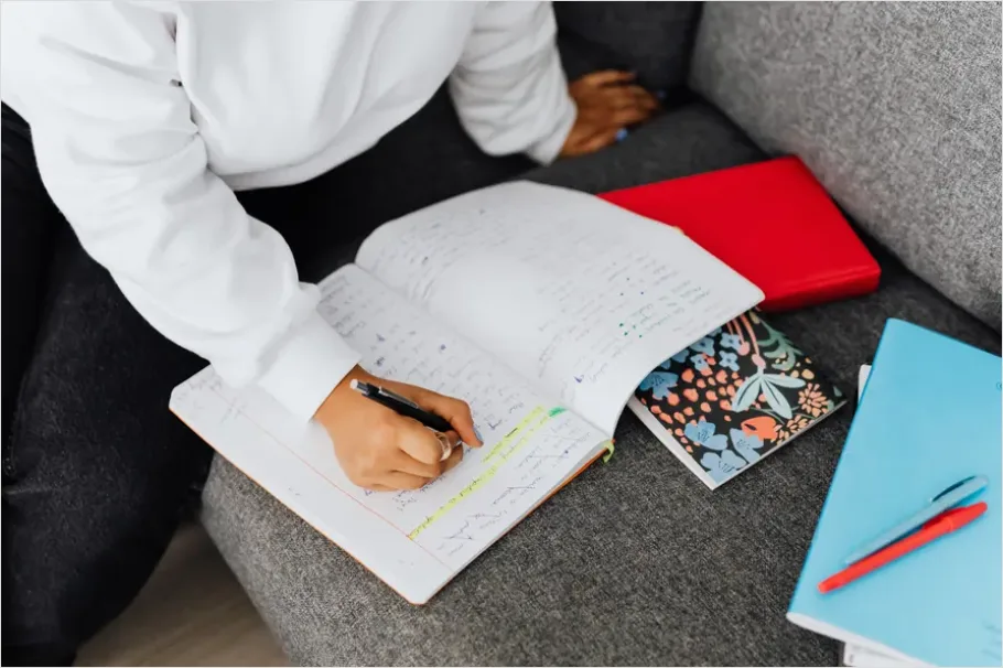Detail Student Writing Notes In Notebook Number 8