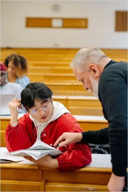 Teacher Helping Student In Classroom 6a39