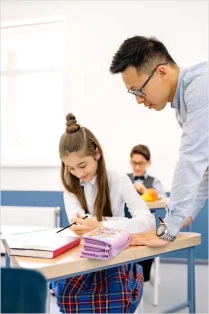 Detail Teacher Helping Student In Classroom Number 4