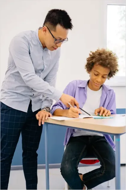 Detail Teacher Helping Student In Classroom Number 7
