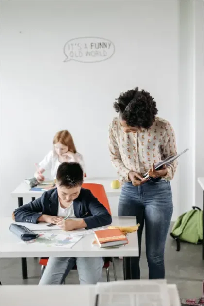 Detail Teacher Helping Student In Classroom Number 10
