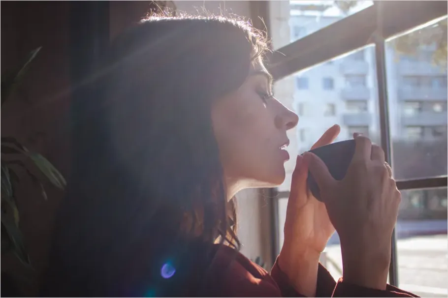 Woman Drinking Tea By Window Aac6