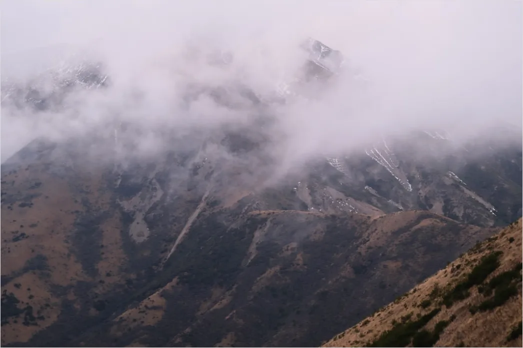 Detail Low Clouds Hugging Mountain Slopes Number 3